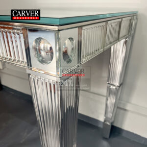 Handcrafted crystal and dining table consoles crafted from glass and stainless steel adorn the crystal table.